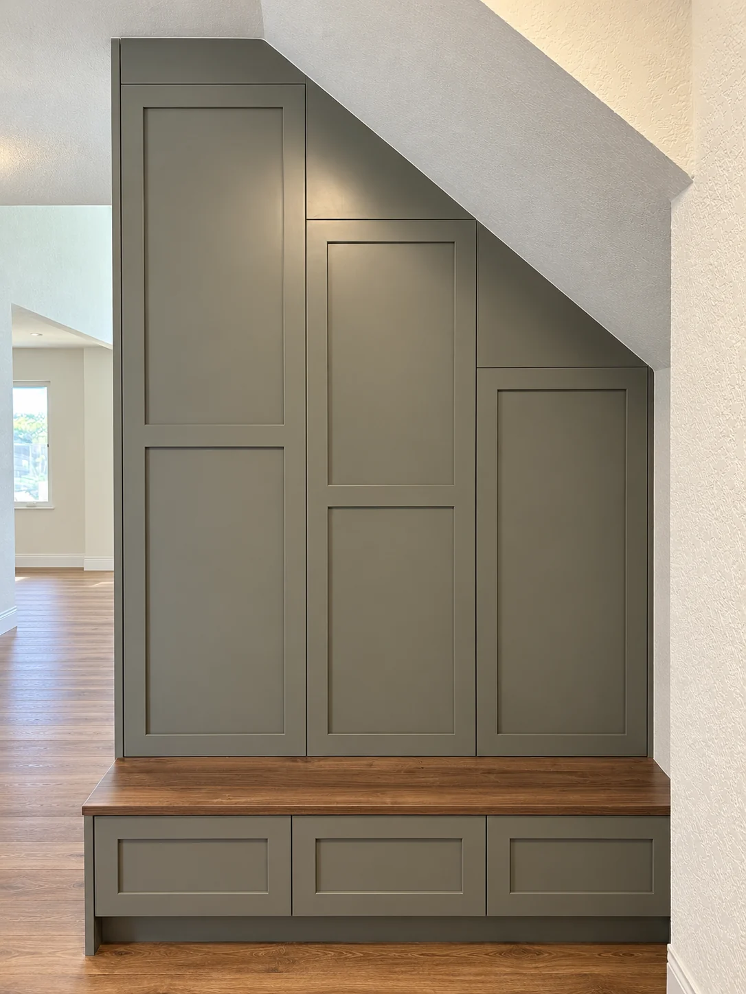Willowleaf Shaker storage fitted beneath the stairs with a dark oak bench